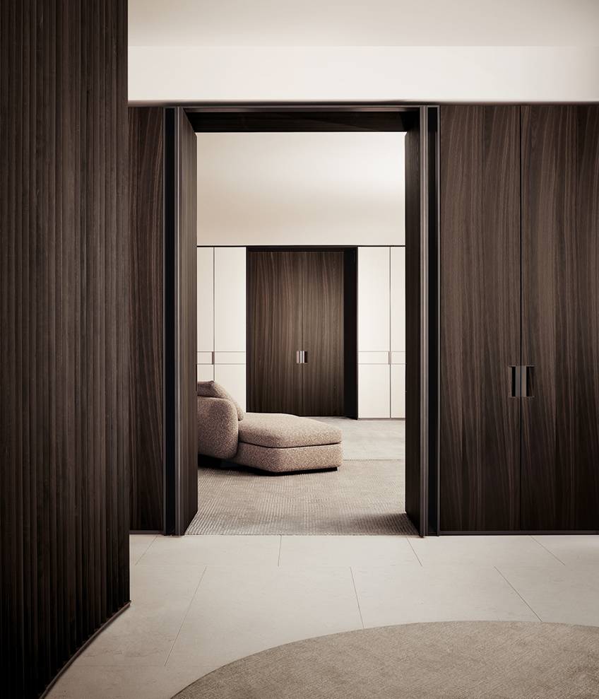 Architectural- Pasillo moderno con paredes de madera oscura y puertas corredizas, que conduce a una habitación minimalista con sillón y suelo alfombrado.